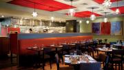 Evoo’s earthy food is served in a modern, open interior with a view of the kitchen.
