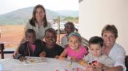 Betancourt with her children, Anna and Joey; her mother, Norma; and their friends Didier, Yvonne, and Pabelo at the Inshuti Mu Buzima/Partners In Health District Hospital in Rwanda