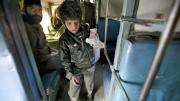 At the train station in Jaipur, India, collecting empty water bottles fetches about 100 rupees ($2) a day. Here, eight-year-old Badal searches inside a train car. 