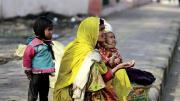 Families make their homes on a sidewalk adjacent to the train station, and survive by begging.