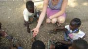 Betancourt engages Sierra Leonean children in a counting game.