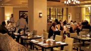 Ambient lighting and comfy chairs star in the second-floor dining room. 