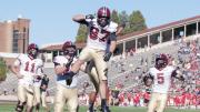 Tight end Cameron Brate (87) went airborne after catching a late-game touchdown pass that locked up the Harvard win. Behind him are quarterback Michael Pruneau (11), tackle Cole Toner (78), and wideout Ricky Zorn (5). Zorn led the Crimson receiving corps with seven catches for 64 yards. 