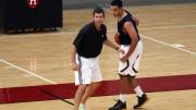 Besides discussing how he approaches coaching, Boston Celtics head coach Brad Stevens (at left) ran drills with members of the Harvard club basketball team, including James McCaffrey ’15.