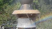 Mist and jets of water spray from the top of the fountain at a Roxbury Park.