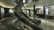 An elegant interior spiral staircase leads to exhibits.