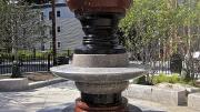 A silhouette can be seen in the negative space around the fountain at a Roxbury park.