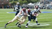 Junior prom: Three members of the class of ’16, defensive back Sean Ahern (6), Scott Peters (in the middle), and linebacker Matt Koran (59), halted Hoyas receiver Jake DeCicco in his tracks.