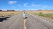 Kunho Kim celebrating on a deserted road in Canyonlands National Park, Utah