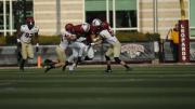 Even with Quinn Smith (11) helping out, Leopard runner DeSean Brown (30) was unable to get past the Crimson senior defensive back double team of Sean Ahern (6) and Scott Peters (44).