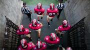 Photo of Harvard football players heading onto the field