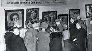 Harvard eventually acquired a Van Gogh self-portrait and the Emil Nolde painting The Mulatto, seen at far left in this photograph of visitors to the Exhibit of Degenerate Art.