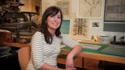 Hulsey in her studio, with letterpress machines behind her