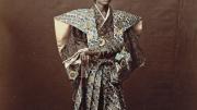 1870s Japan: a hand-tinted albumen print by Raimund von Stillfried showing a man costumed as a samurai warrior