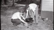 Forensic pioneer Joseph T. Walker (at left) collects blood and scraps of flesh from the bathtub drain of a 1936 murder victim.