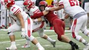 Harvard's Brogan McPartland breaks through to tackle Cornell quarterback Richie Kenney for a loss. In his first 2019 appearance, the senior defensive lineman had two of the Crimson's six sacks.