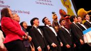 The Harvard Krokodiloes sing with Muppets and Harvard and Sesame Street leaders. 