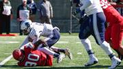 Harvard's Truman Jones drags down Howard quarterback Quinton Williams.