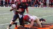 Isaiah Wingfield and Brogan McPartland of Harvard tackle Princeton quarterback.
