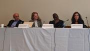 Photo of three speakers seated at a table