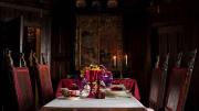 A Gothic-style dining room, with the table set for a formal dinner