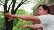 Master Yon Lee extends his hands in a tai chi pose.