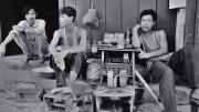 Black and white photo, titled “Three Tobacconists”