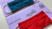 photograph of two election mail envelopes with face masks