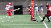  Harvard junior safety James Herring gets a hand on the punt of Cornell's Koby Kiefer.