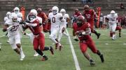 Running back Aidan Borguet runs up field with ball in hand