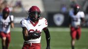 Khalil Dawsey runs downfield with the football.