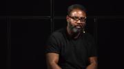 Reginald Dwayne Betts seated in front of a black background