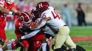 Cornell running back Eddy Tillman finds his path blocked by Harvard defenders. The Crimson limited the Big Red to 65 yards on 37 carries.