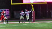 Senior Kobe Joseph, who broke in and blocked a Cornell punt,accompanies junior Jelani Machen as he holds the ball aloft and runs into the end zone to give Harvard a second-quarter lead.