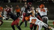 Harvard quarterback Charlie Dean gets off a pass despite Princeton rush.