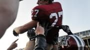 Photograph by Meredith Keffer With Crimson in triumph flashing: Captain Collin Zych rode off on his teammates’ shoulders after the final whistle. The 28-21 victory was Harvard’s fourth straight over Yale, and its ninth in the last 10 Harvard-Yale games.