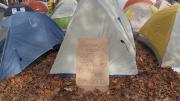 A protester's sign outside of a tent.