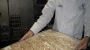 Savinien Caracostea displays a tray of macarons created in the Harvard kitchen.