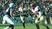 Quarterback Conner Hempel directed the Crimson offense, passing for 209 yards and two touchdowns and gaining 57 yards on 10 carries. The Yale defender is safety Robert Ries; blocking for Hempel is running back Seitu Smith III.