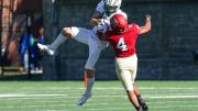 Harvard defensive back Max Jones knocks a ball out of the hands of Dartmouth wide receiver Drew Estrada