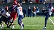 Penn's kicker, Jake Haggard, punts the football. 