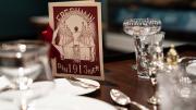 A table with a fancy menu and table settings.