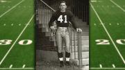 Carroll Lowenstein standing at the base of staircase