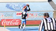 Receiver Adam West makes a leaping catch over a Columbia defender.
