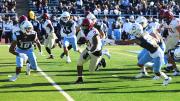 Running back Aidan Borguet runs up field through Columbia defenders.