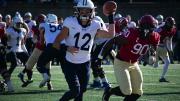 Yale quarterback Nolan Grooms being pursued; he ran for 63 yards and threw for 144.