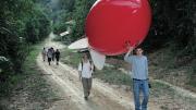 Newell and Horowitz walk the weather balloon to the launch site