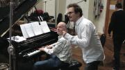 Fox Music president Robert Kraft, at the piano, works with film director Darren Aronofsky. 
