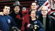 Four New York firefighters with John Weidman and <i>Sesame Street</i> character Elmo in 2001. 