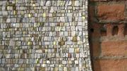 A detail showing the mosaic&rsquo;s marble, glass, and gold elements 